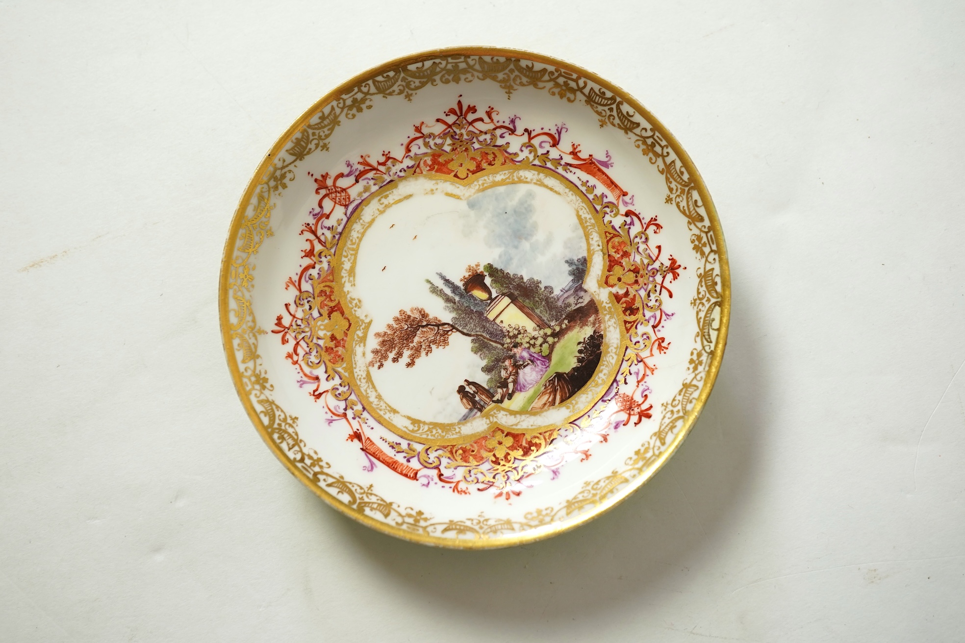 A Meissen cup and saucer, similar tea bowl and two saucers, c.1735-45